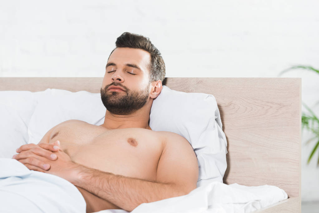 stock photo handsome man sleeping bed morning